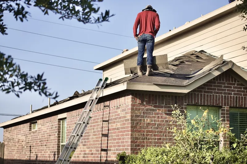 Professional roofer working on a residential roof in Knoxboro